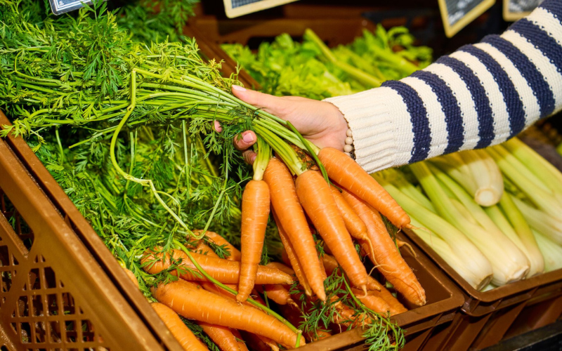 Buying carrots at local market