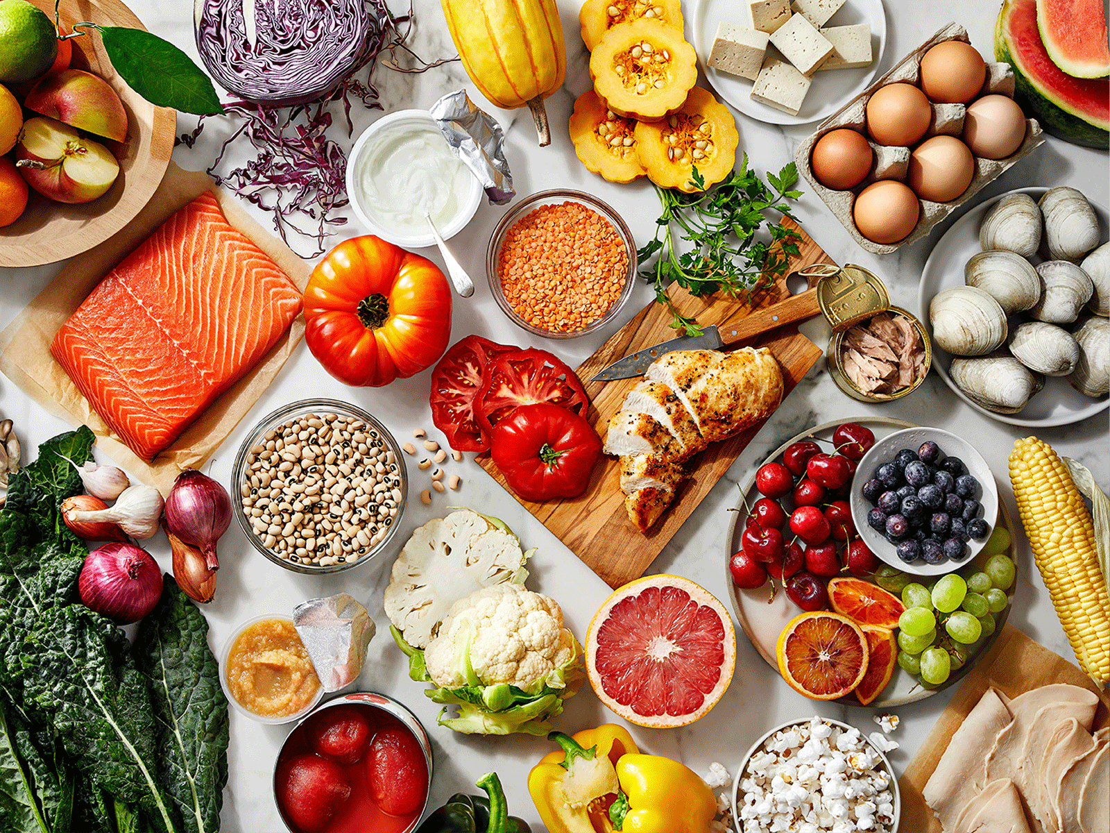 A collection of fruits and vegetables displayed on a table in an artful way.