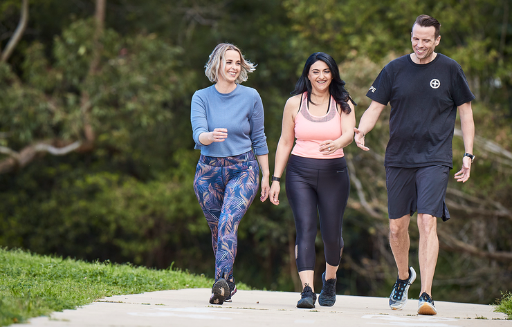 Three people walking in a park