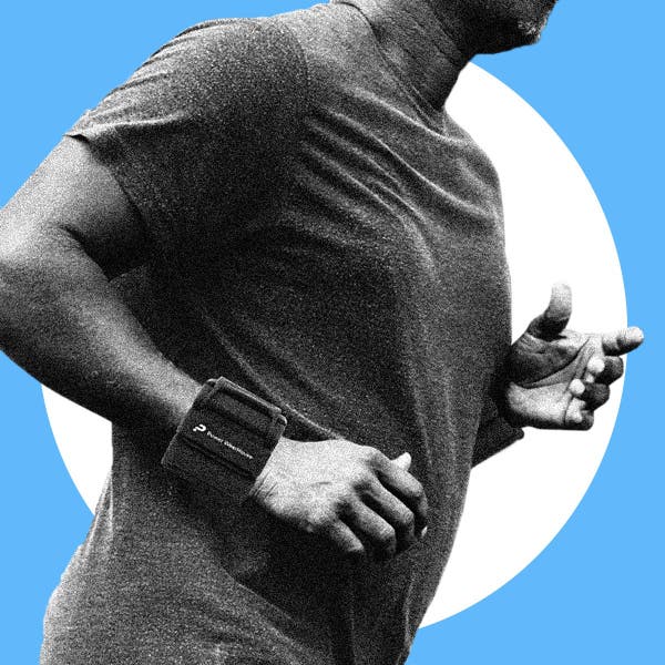 Man jogging while wearing wrist weights