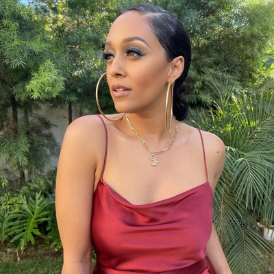 Tia out in her backyard, surrounded by lush greenery