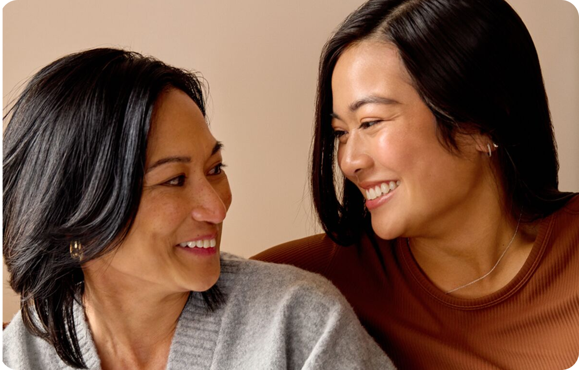 Two women chatting while holding phones