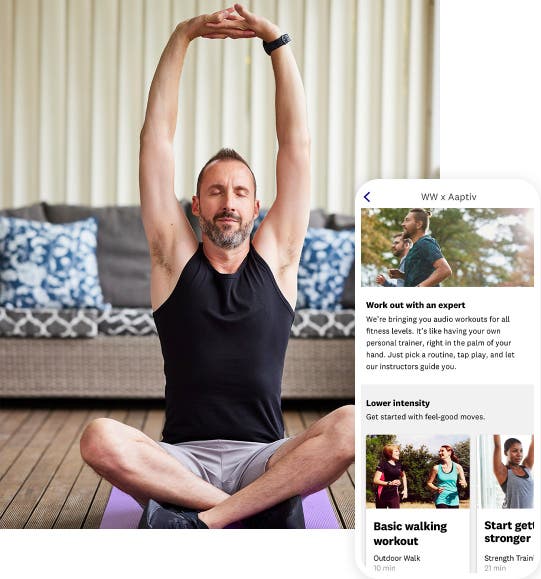 A man sits cross-legged on a yoga mat. His eyes are closed and his arms are raised above his head with his fingers interlaced in a yoga pose. Superimposed to the right is a mobile app screenshot of the Aaptive content page with various fitness program options.