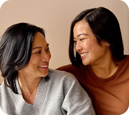 Two women chatting while holding phones