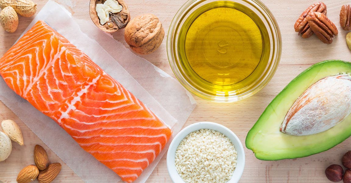 Lebensmittel mit gesunden Fetten wie Lachs, Öl, Avocado, Nüsse