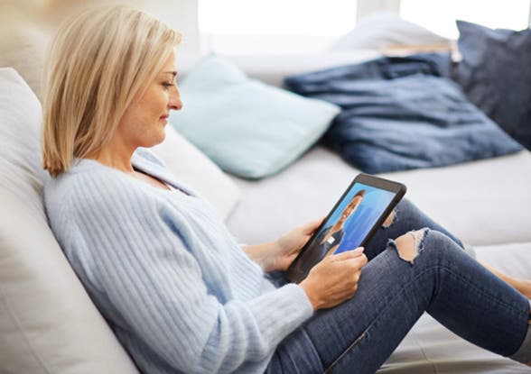 WW Mitglied Monika schaut auf Tablet mit WW Coach