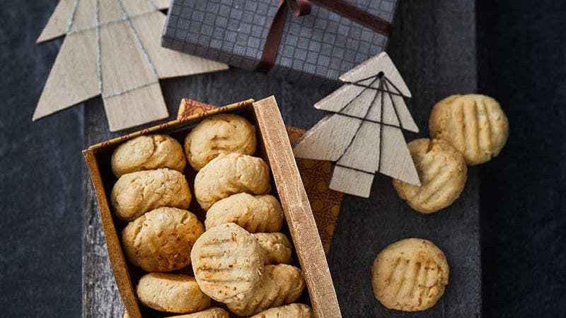 Helle Cookies in einer Schachtel auf dunklem Hintergrund