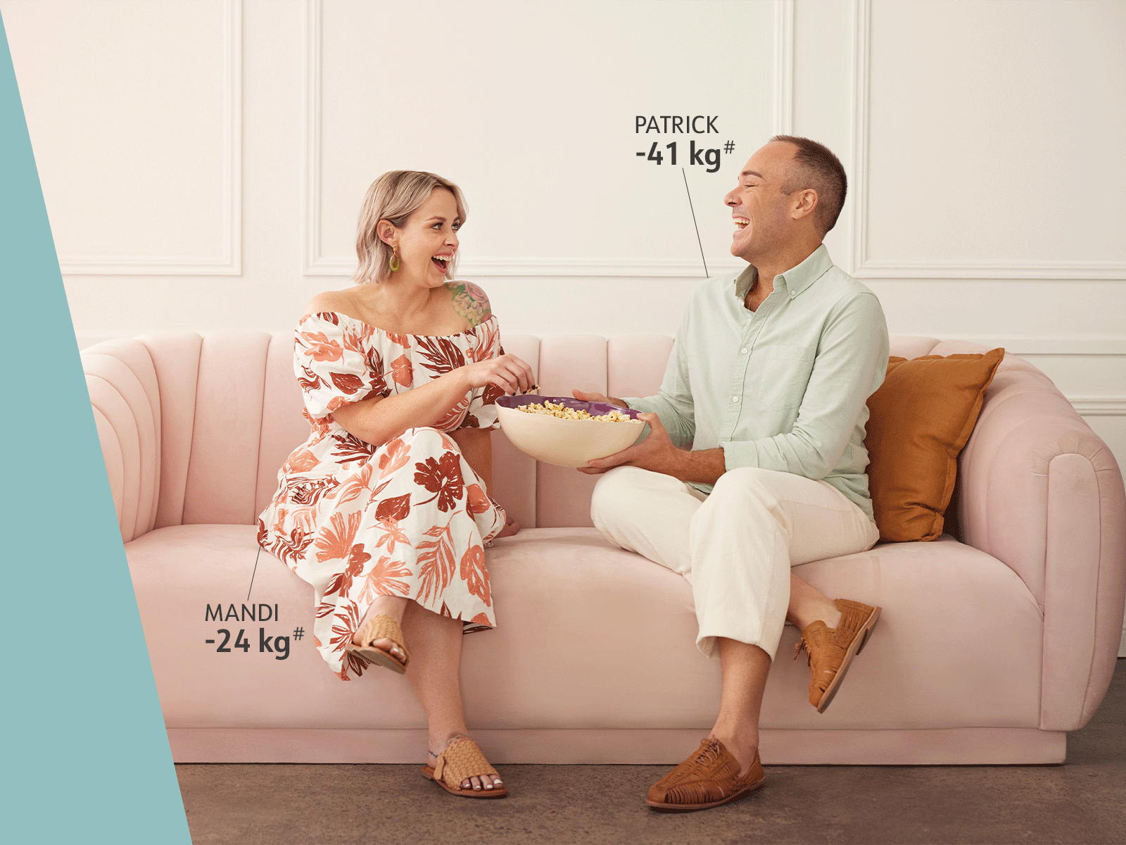 Members Mandi and Patrick sitting on couch eating popcorn