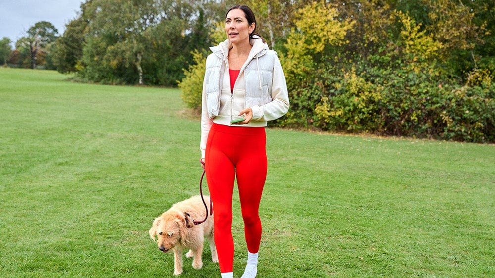 a woman walking a dog