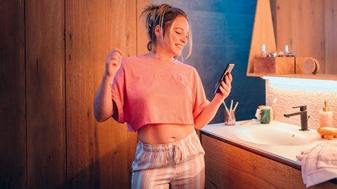 Lady wearing pink shirt holding her mobile