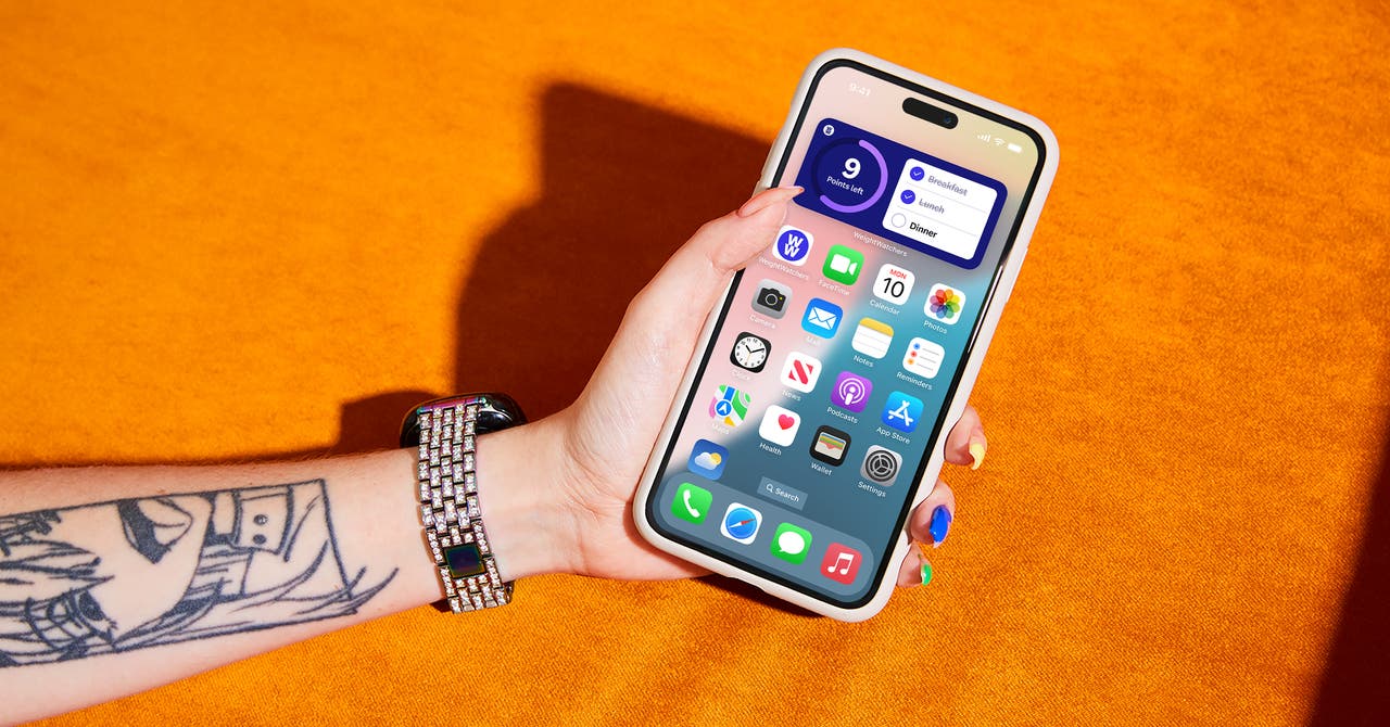 A person holds an iPhone, showcasing a blend of technology and personal expression.
