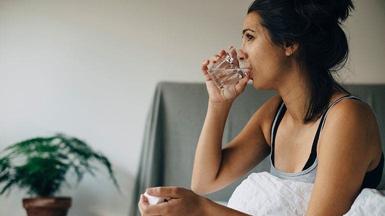 woman with diabetes drinking glass of water