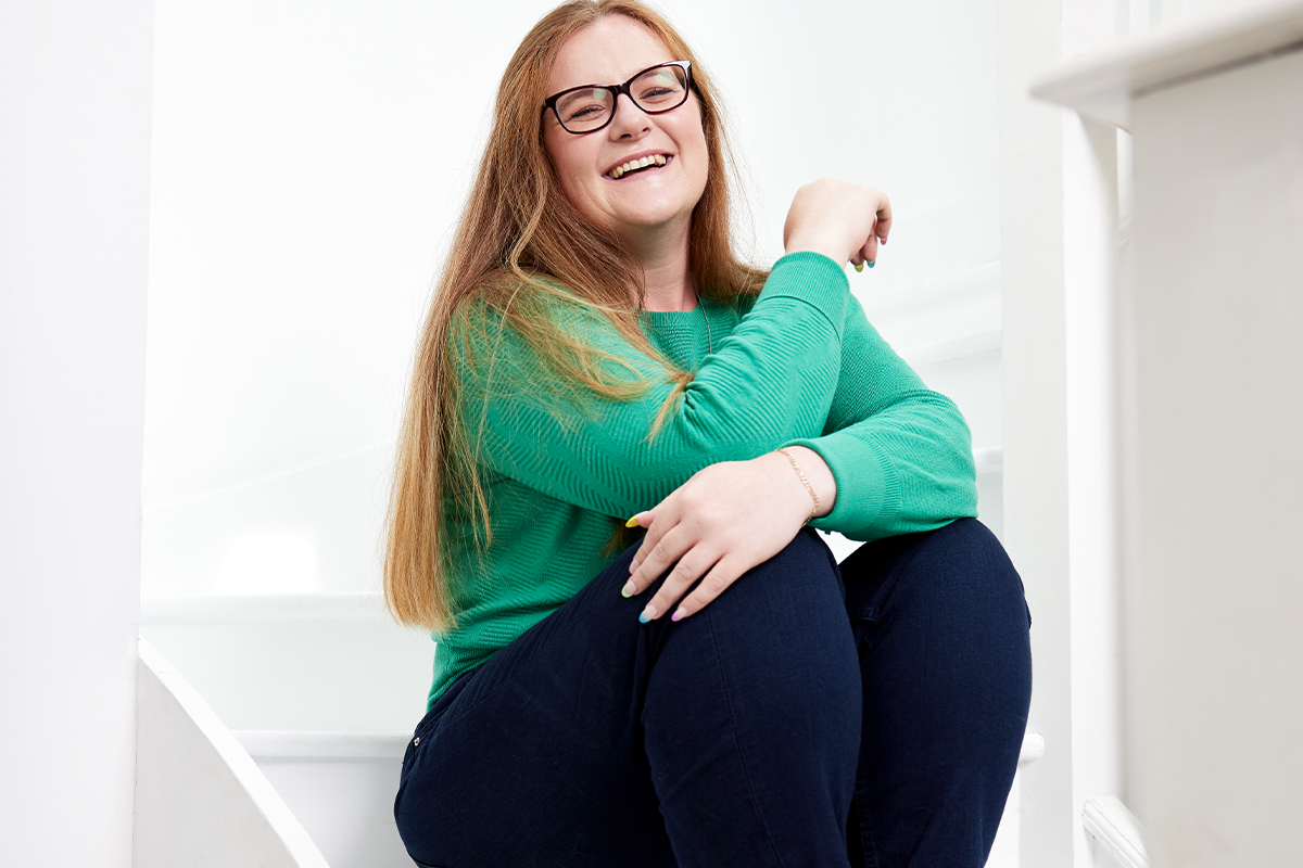 Image of Willow sat on some stairs, smiling Image of Willow sat on some stairs, smiling