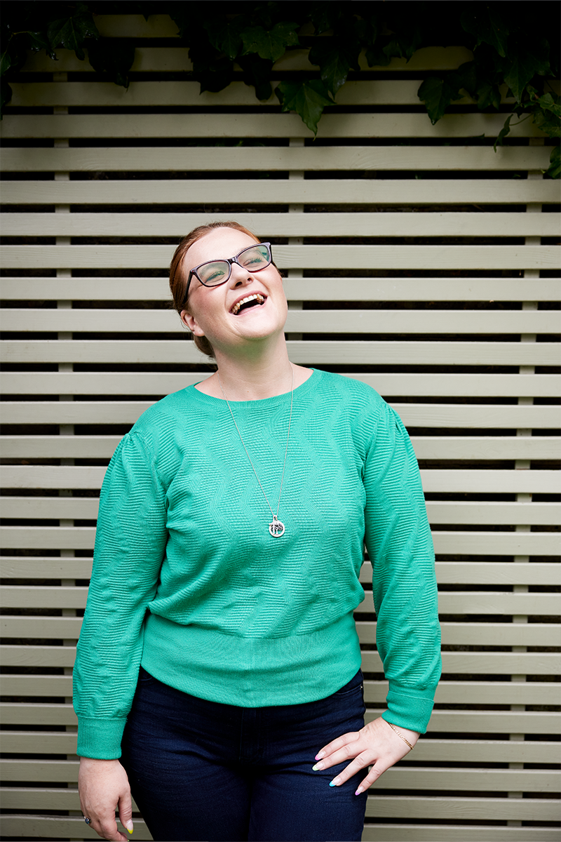 Image of Willow laughing and holding her hip