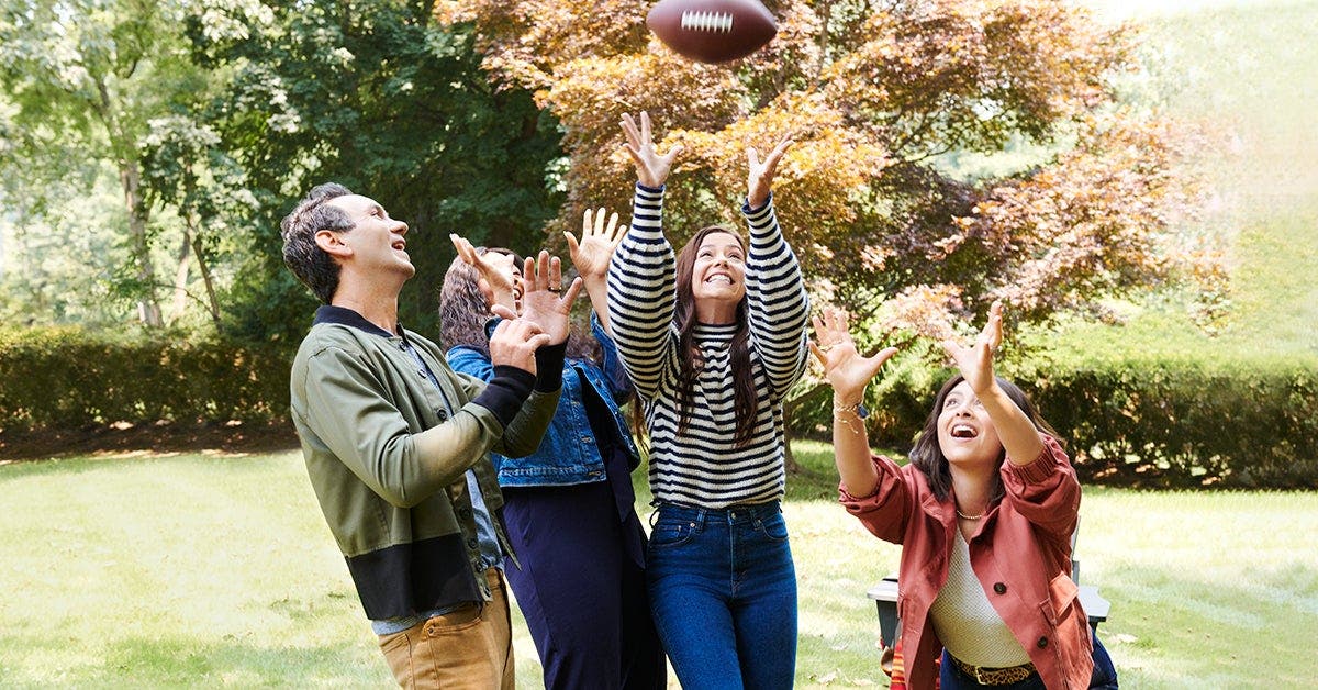 a group of people playing with a football