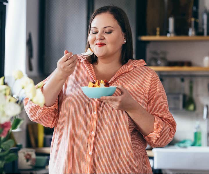 Woman eating a bowl of popcorn.