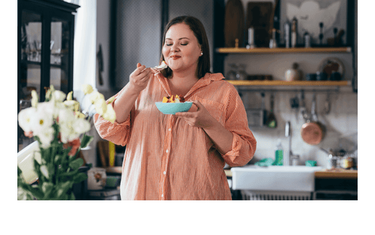 Woman eating a bowl of popcorn.