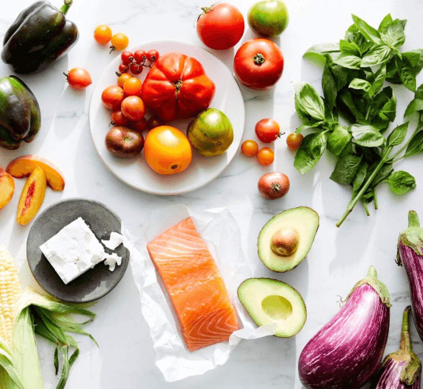 A collection of fruits and vegetables displayed on a table in an artful way.