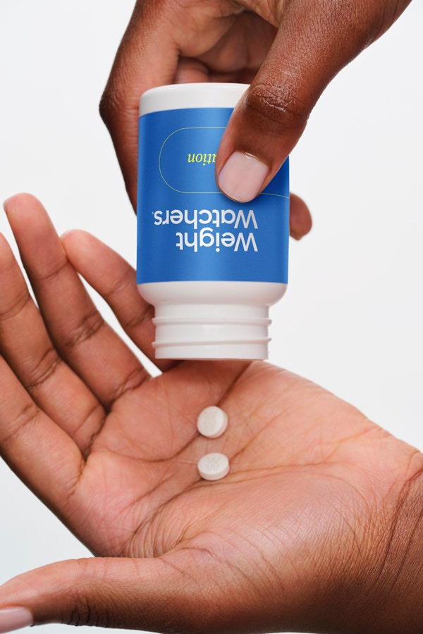 oral weight-loss medication pills in palm of hand