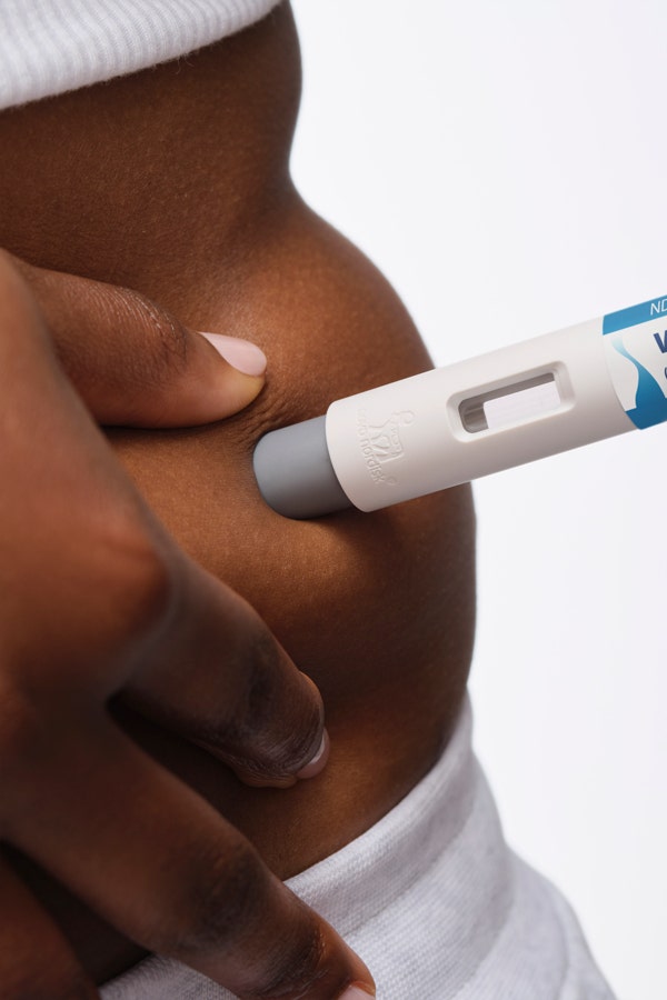injectable weight-loss medication pen in abdomen