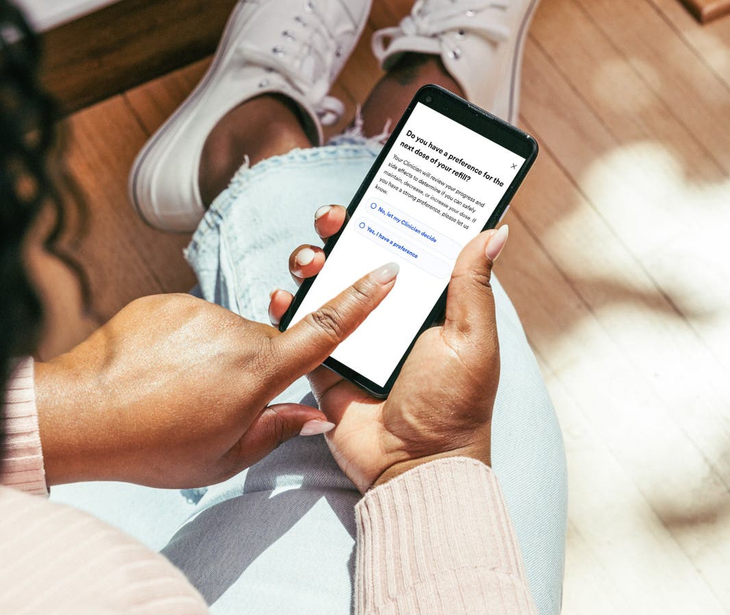 woman using WeightWatchers app on her cellphone