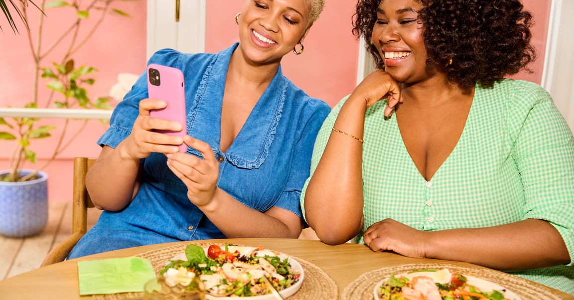 two friends looking to the phone