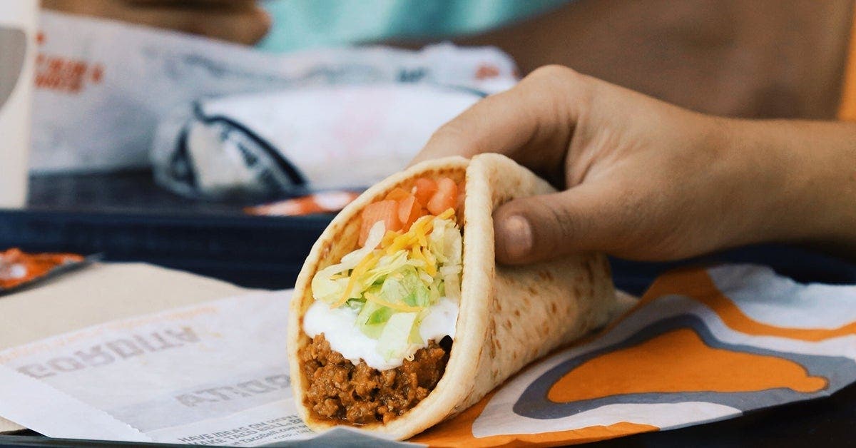 Soft ground beef taco with tomatoes, lettuce and cheese