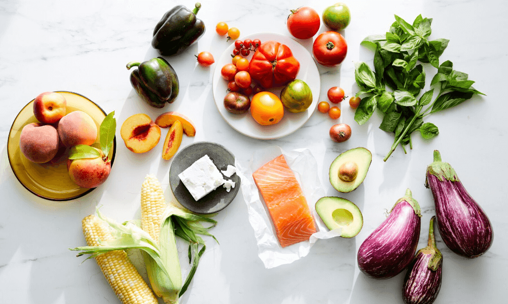 A collection of fruits and vegetables displayed on a table in an artful way.