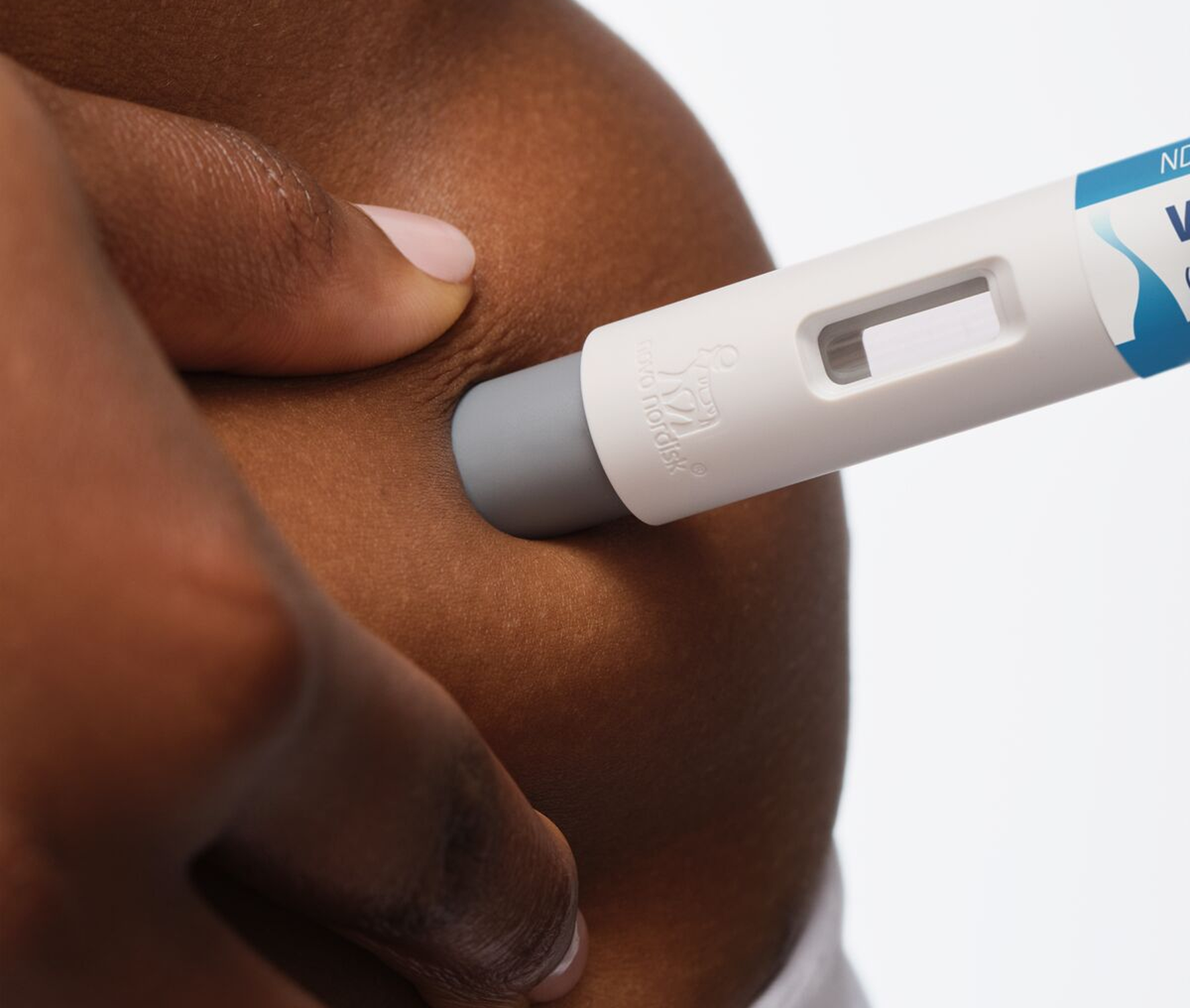 person injecting Wegovy pen