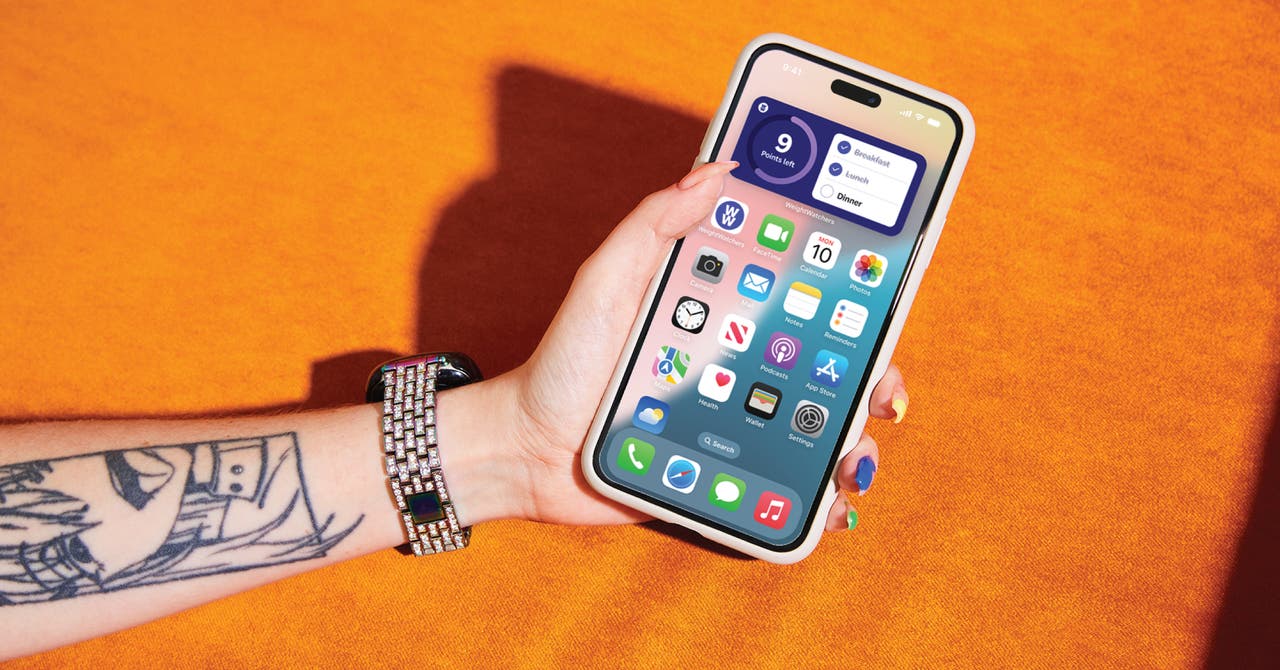 A person holds an iPhone, showcasing a blend of technology and personal expression.