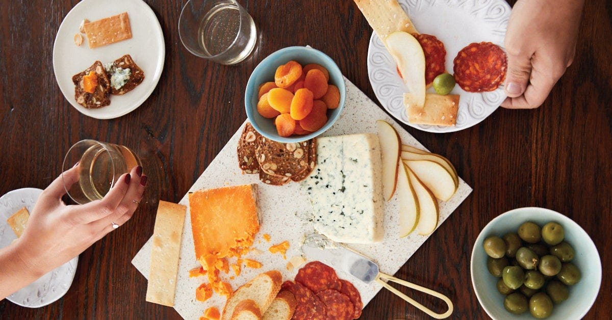 A table set with plates and glasses of wine for a formal dinner event.