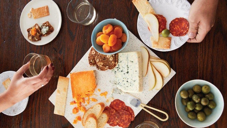 A table set with plates and glasses of wine for a formal dinner event.