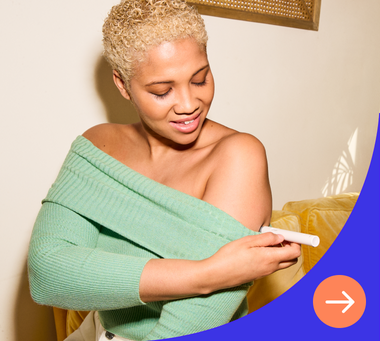 Woman looks at injectable medication while holding phone