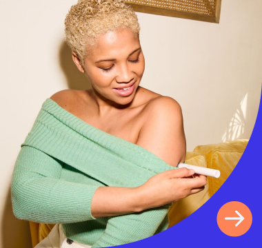 Woman looks at injectable medication while holding phone