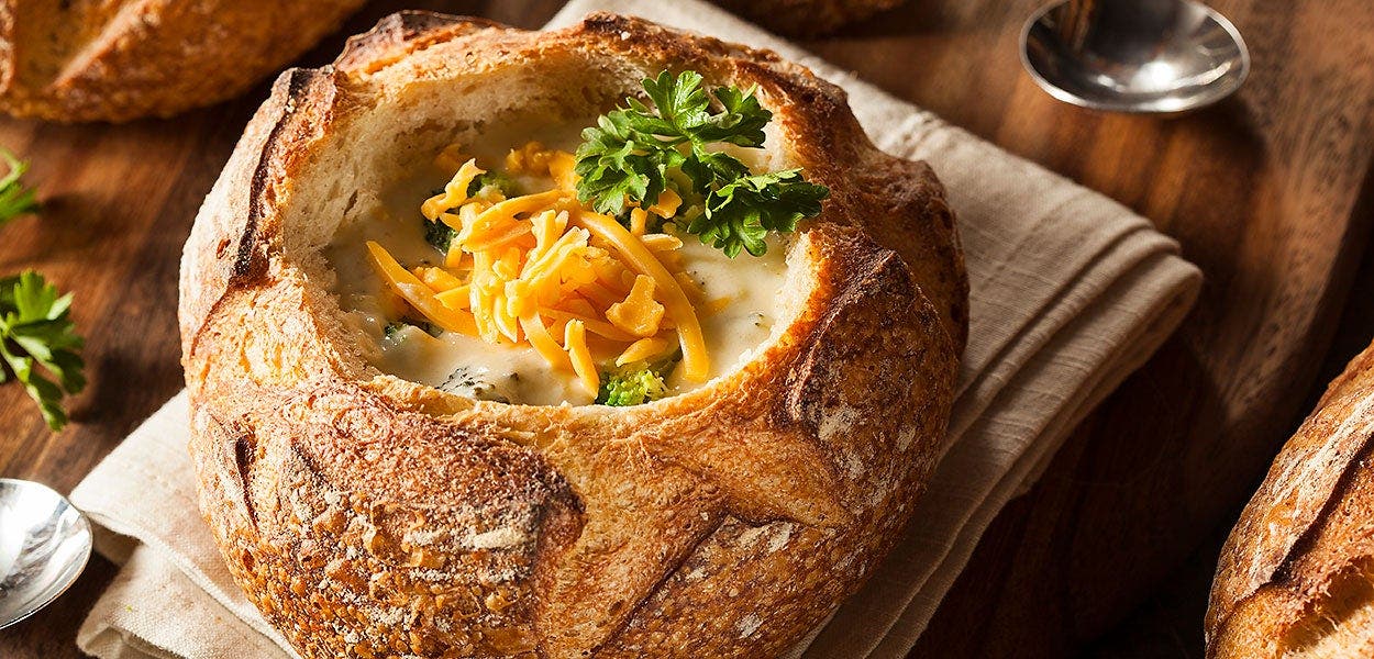 Creamy broccoli cheddar soup in a bread bowl