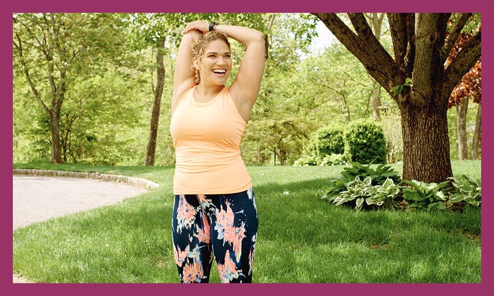 WW member Cassie D, stretching her triceps in the park