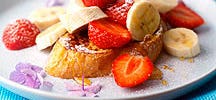 French Toast with Strawberries and Bananas and Honey Drizzle