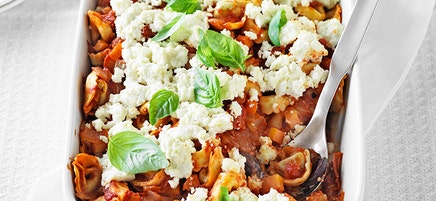 Baked tortellini with tomato, olives and ricotta