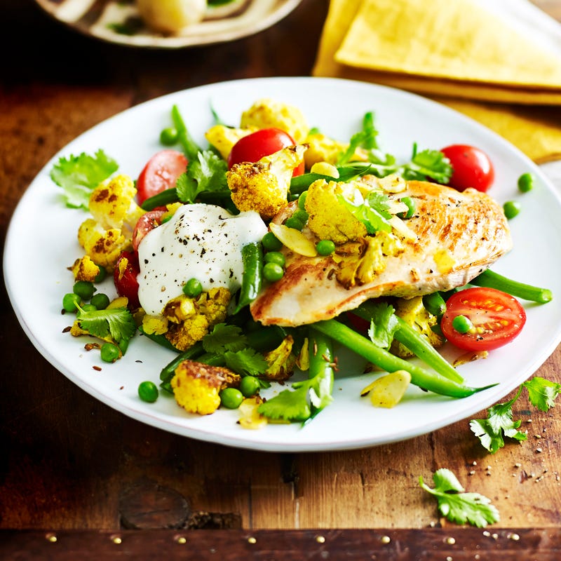 Chicken with cumin roasted cauliflower and cherry tomatoes
