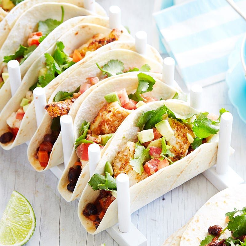 Tacos with grilled spicy fish, black beans and avocado salad