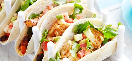 Tacos with grilled spicy fish, black beans and avocado salad