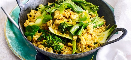 Turmeric spiced rice bowl with stir-fried chicken and greens