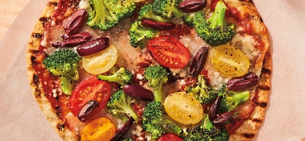 Grilled broccoli, cherry tomato, and olive tortilla pizzas