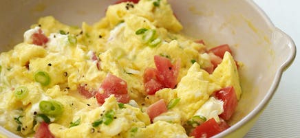 Creamy scrambled eggs with scallions and tomatoes