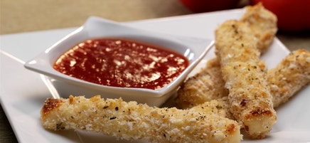 Baked mozzarella sticks with spicy tomato dipping sauce