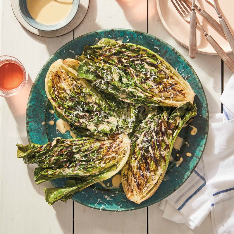 round platter topped with grilled romaine sprinkled with Parmesan and served with Caesar dressing