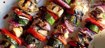 Mojo-marinated chicken and vegetable kebabs with mixed greens