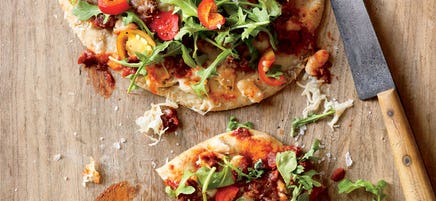 Spicy white bean, caponata, and arugula pizzas