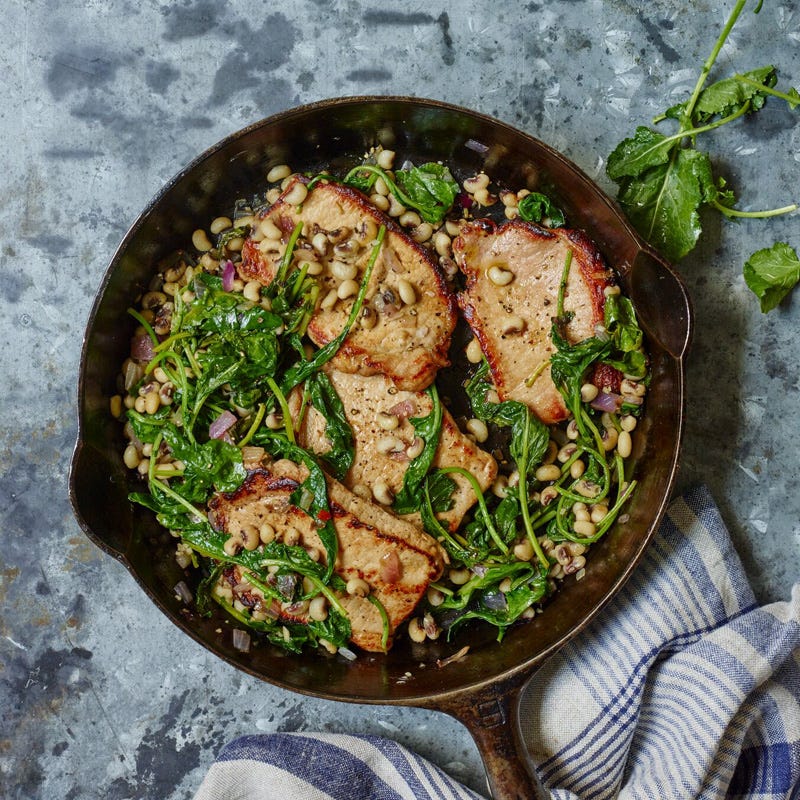 Cider-brined pork chops with greens and peas