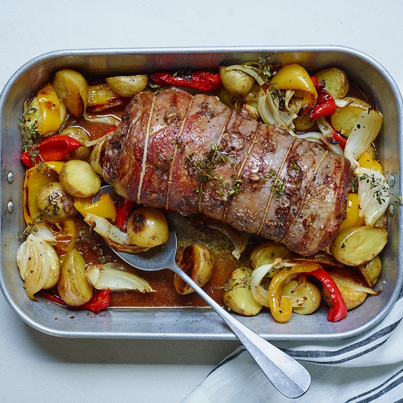 Garlic-studded roast leg of lamb with new potatoes